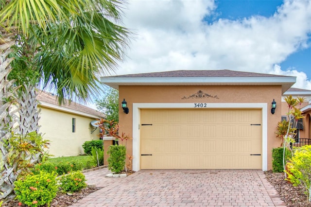 garage featuring decorative driveway