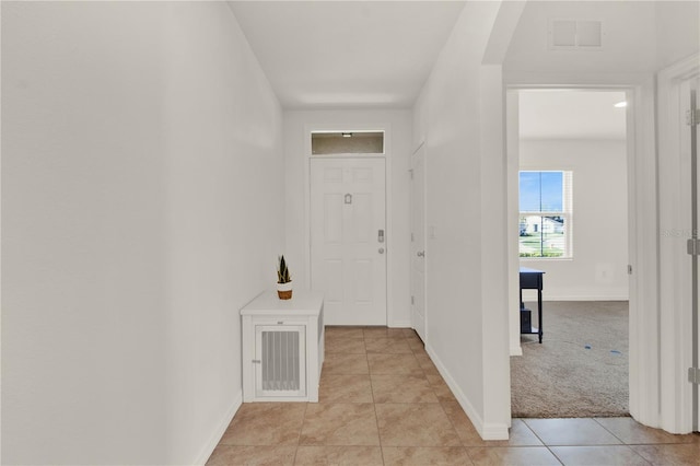 hallway with light colored carpet