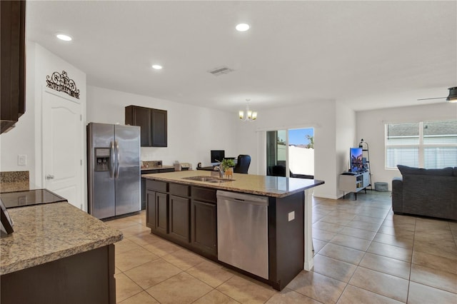 kitchen featuring sink, stainless steel appliances, dark brown cabinetry, and a wealth of natural light