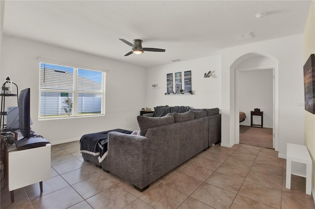 living room featuring ceiling fan and tile patterned flooring