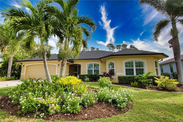 39 Tee View Pl, Rotonda West, FL 33947 - view of front of house featuring stucco siding, concrete driveway, a front yard, and a garage