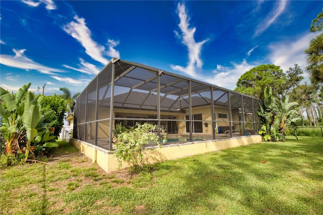 back of property featuring a yard and a lanai