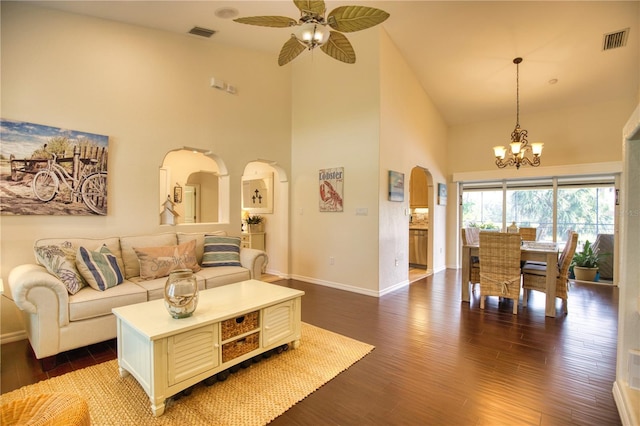 39 Tee View Pl, Rotonda West, FL 33947 - living area with high vaulted ceiling, arched walkways, a chandelier, dark wood-style flooring, and baseboards