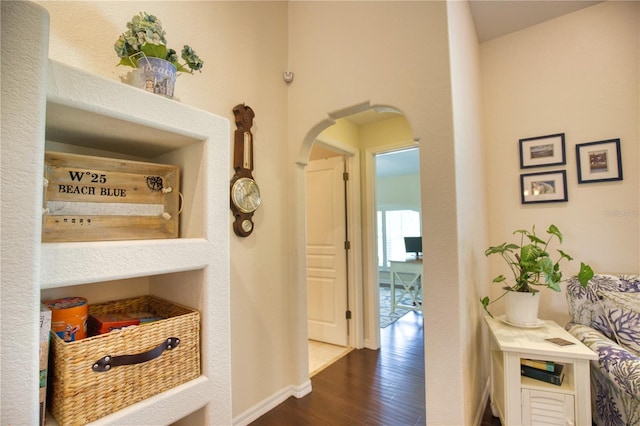 39 Tee View Pl, Rotonda West, FL 33947 - hallway featuring arched walkways, dark wood finished floors, and baseboards