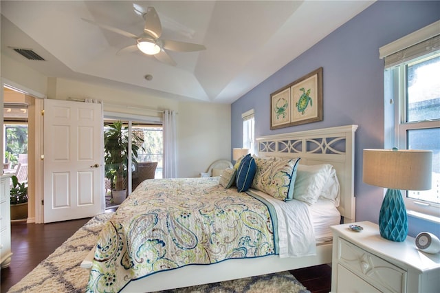 bedroom featuring access to outside, multiple windows, and ceiling fan