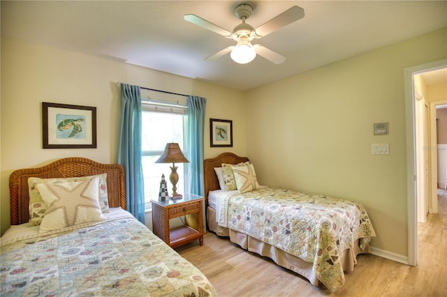 bedroom with ceiling fan and light hardwood / wood-style flooring