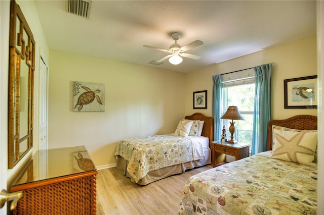 bedroom with a closet, light hardwood / wood-style floors, and ceiling fan