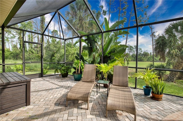 view of patio featuring a lanai