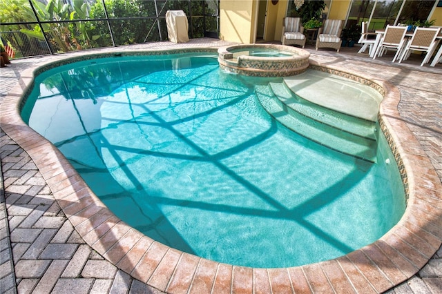 39 Tee View Pl, Rotonda West, FL 33947 - view of swimming pool with a pool with connected hot tub, a patio, and glass enclosure