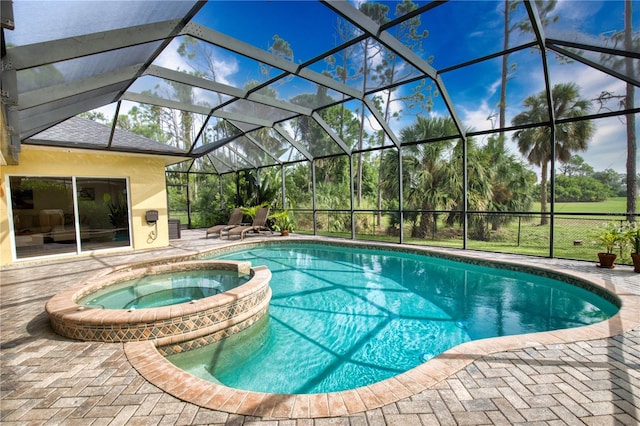 view of swimming pool featuring an in ground hot tub, a patio, and glass enclosure