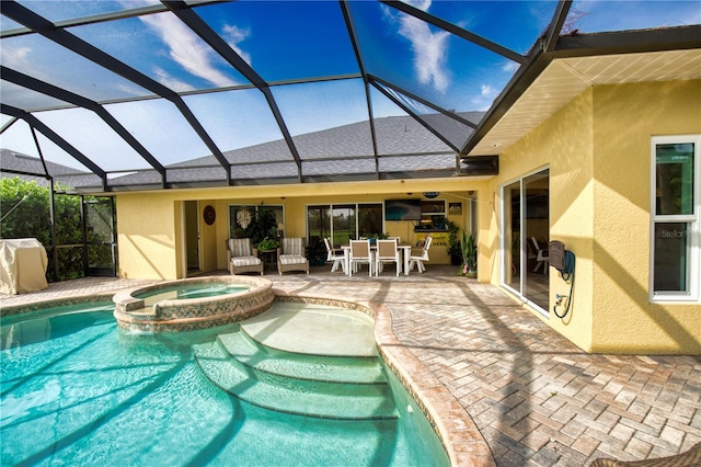 view of pool featuring an in ground hot tub, a patio, and a lanai