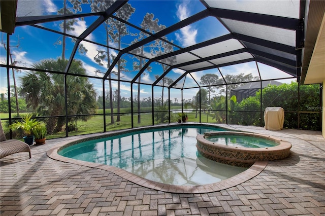 view of swimming pool with a patio, an in ground hot tub, and glass enclosure