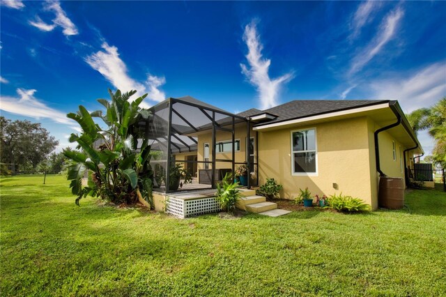 39 Tee View Pl, Rotonda West, FL 33947 - rear view of property featuring stucco siding, a yard, glass enclosure, and a shingled roof