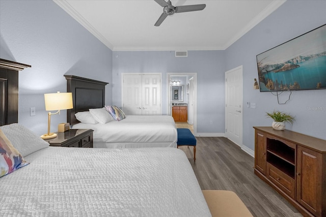 bedroom featuring ensuite bath, ceiling fan, dark wood-type flooring, crown molding, and a closet