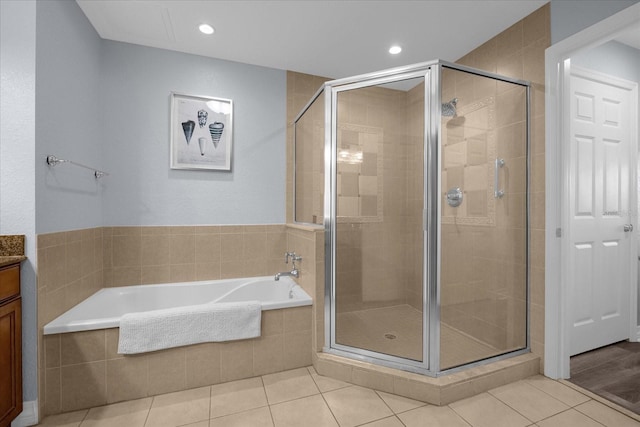 bathroom with shower with separate bathtub, vanity, and tile patterned floors