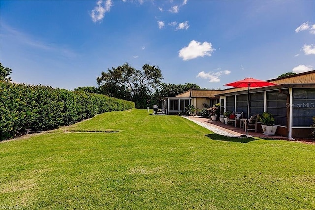 view of yard featuring a sunroom