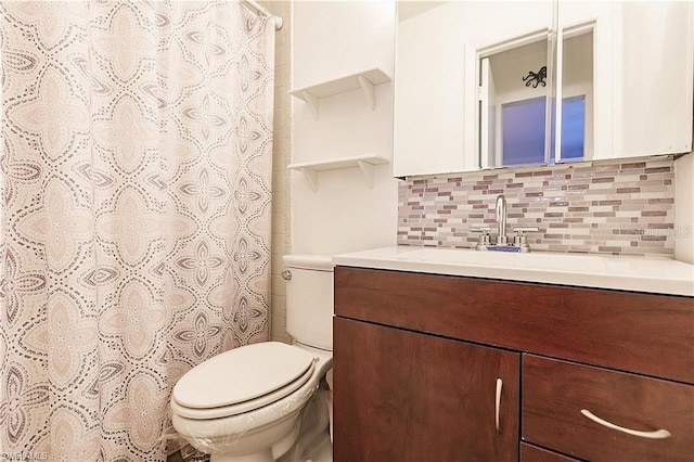 bathroom featuring toilet, walk in shower, vanity, and backsplash