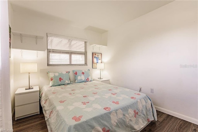 bedroom with dark hardwood / wood-style flooring