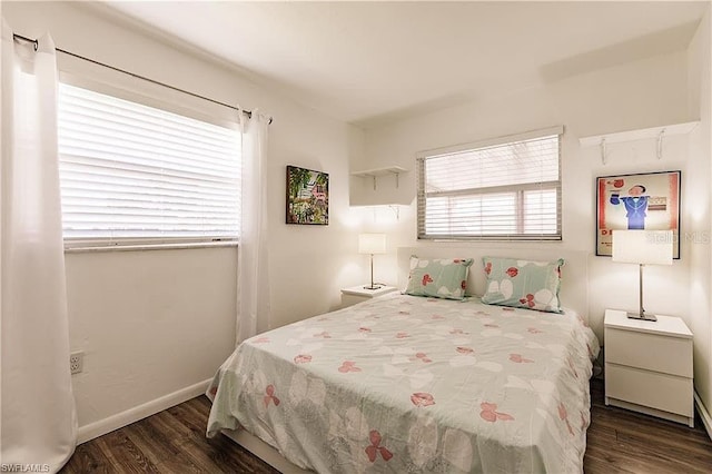 bedroom with dark hardwood / wood-style floors