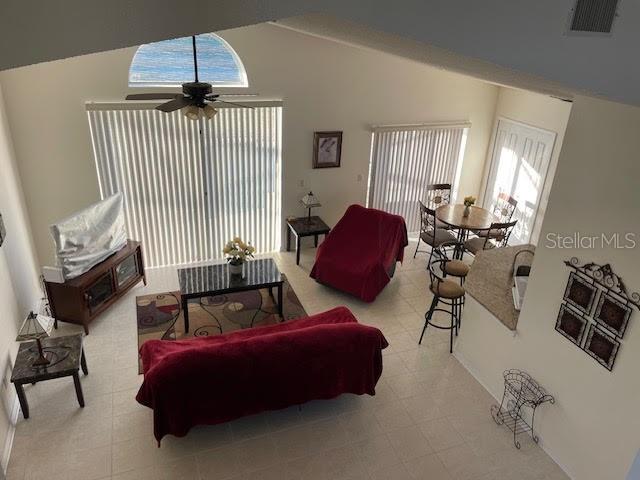 living room with high vaulted ceiling and ceiling fan