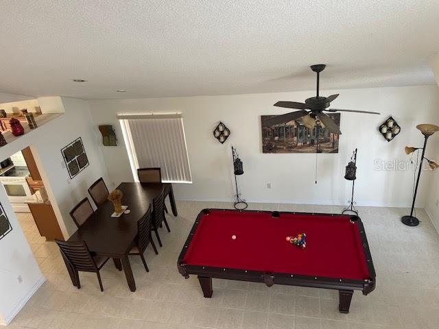 game room featuring pool table, a textured ceiling, and ceiling fan