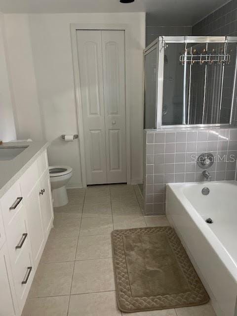 full bathroom with toilet, vanity, separate shower and tub, and tile patterned floors