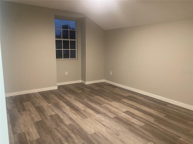 unfurnished room featuring dark wood-type flooring