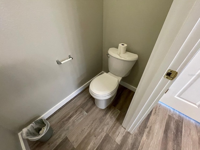 bathroom featuring hardwood / wood-style floors and toilet