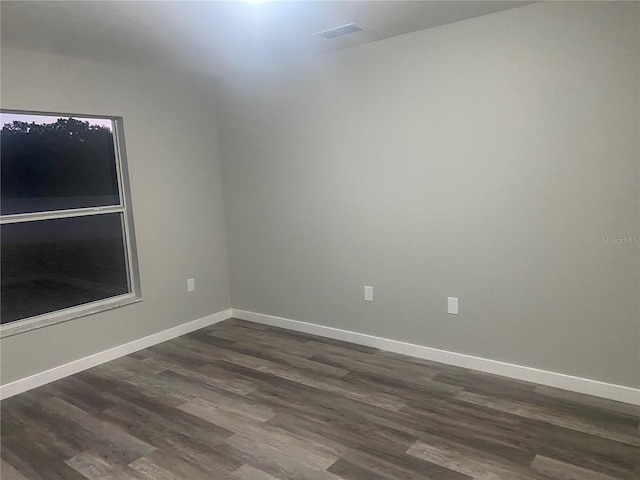 unfurnished room featuring dark hardwood / wood-style flooring