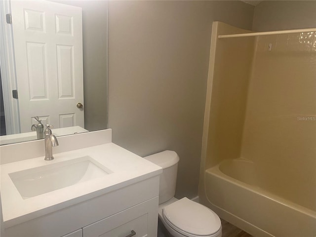 full bathroom featuring vanity, toilet, wood-type flooring, and shower / washtub combination