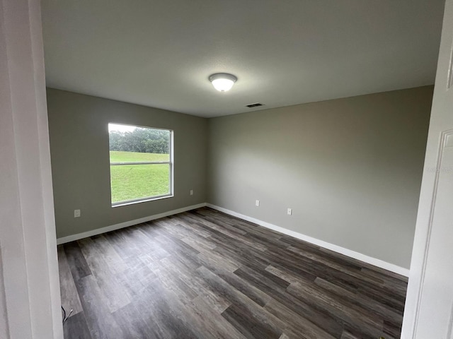 unfurnished room featuring dark hardwood / wood-style floors