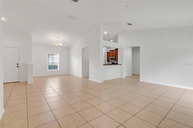 unfurnished living room with a chandelier, vaulted ceiling, and light tile patterned flooring