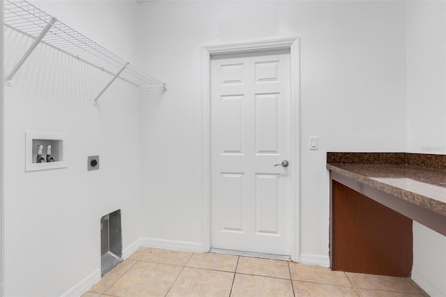 washroom with electric dryer hookup, light tile patterned flooring, and washer hookup