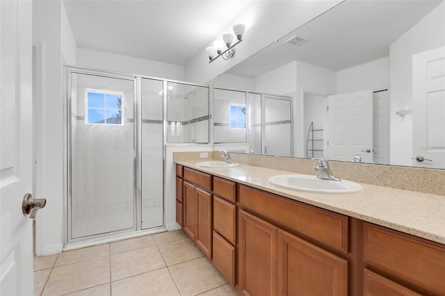 bathroom with vanity, a wealth of natural light, tile patterned floors, and walk in shower