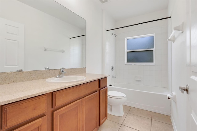 full bathroom featuring toilet, vanity, tiled shower / bath combo, and tile patterned floors