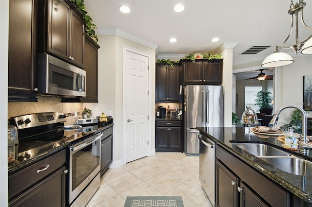 kitchen featuring sink, ornamental molding, ceiling fan, pendant lighting, and appliances with stainless steel finishes