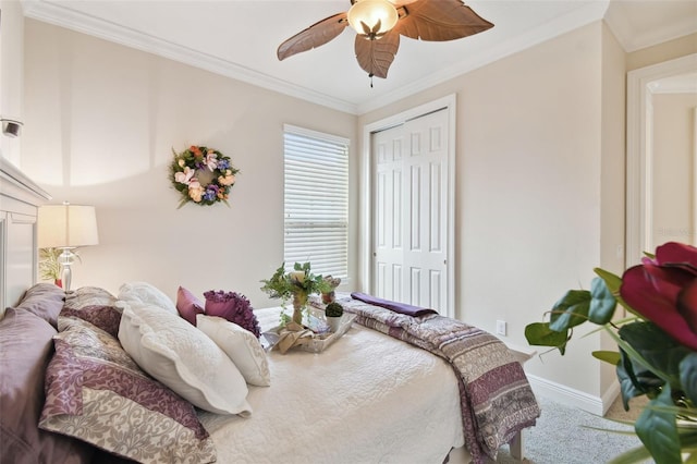 carpeted bedroom featuring ornamental molding, ceiling fan, and a closet