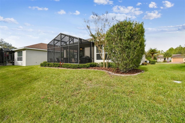 back of house with a lawn and a lanai