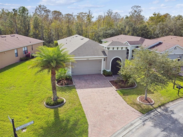 mediterranean / spanish-style house with a front lawn and a garage