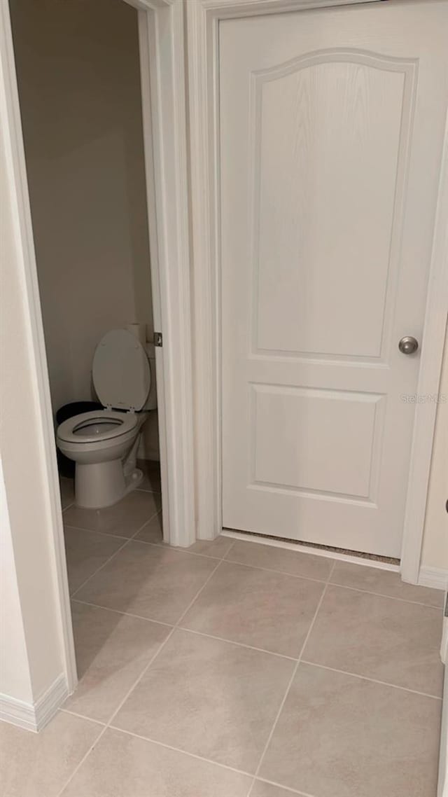 bathroom featuring toilet and tile patterned floors