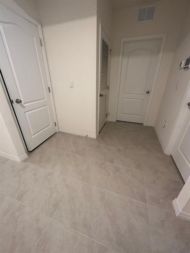 hallway with light tile patterned floors