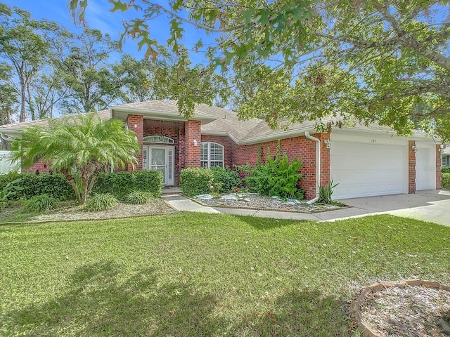 view of front of house with a garage and a front lawn