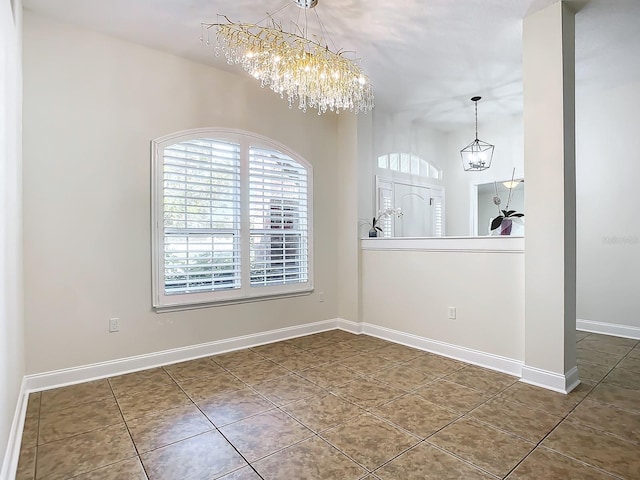 unfurnished dining area featuring tile patterned flooring and an inviting chandelier