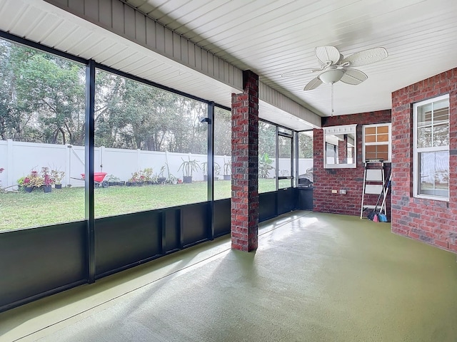 unfurnished sunroom with ceiling fan