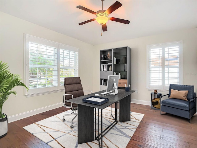 office area with ceiling fan, dark hardwood / wood-style floors, and a wealth of natural light