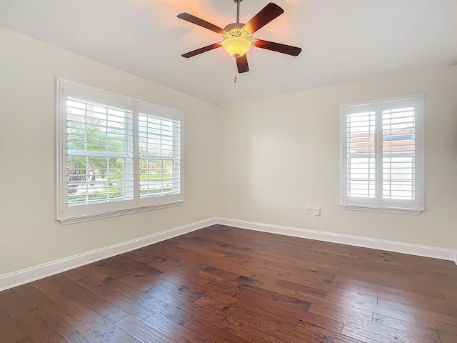 spare room with dark wood-type flooring and ceiling fan