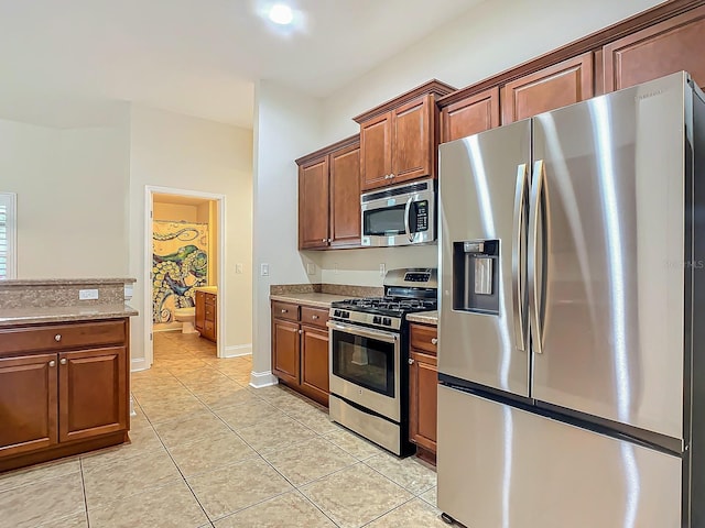 kitchen featuring appliances with stainless steel finishes and light tile patterned floors