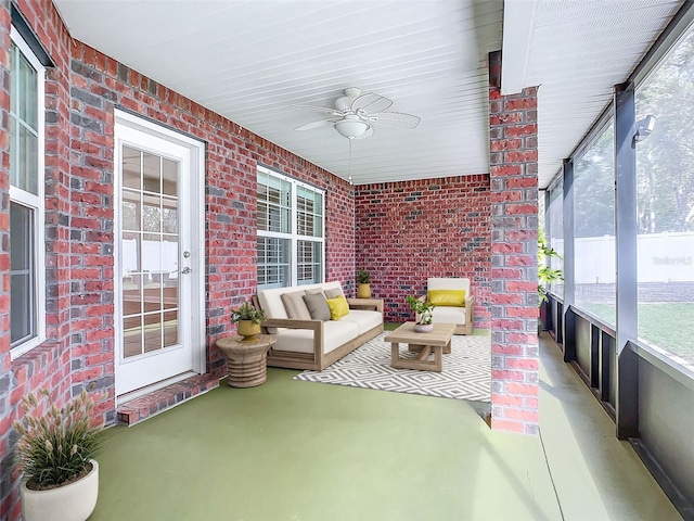 unfurnished sunroom with ceiling fan