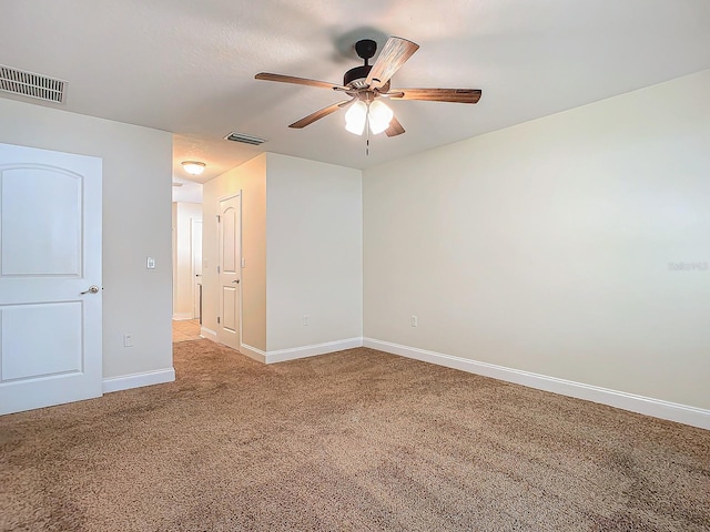 spare room with light carpet and ceiling fan