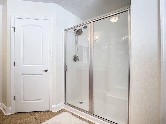 bathroom featuring a shower with door and tile patterned floors